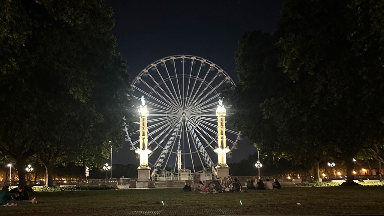 Ferris wheel lit up within the night