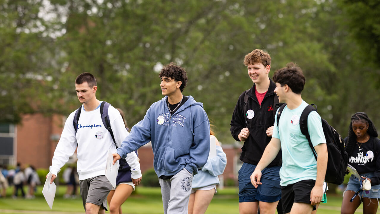 A group of students walking on the Quad
