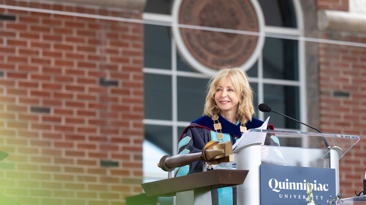 Judy Olian speaks at a podium