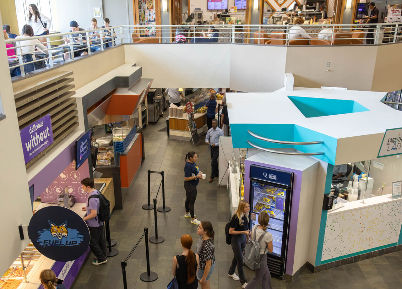 Students eat together on the second floor while others browse the dining options in Cafe Q