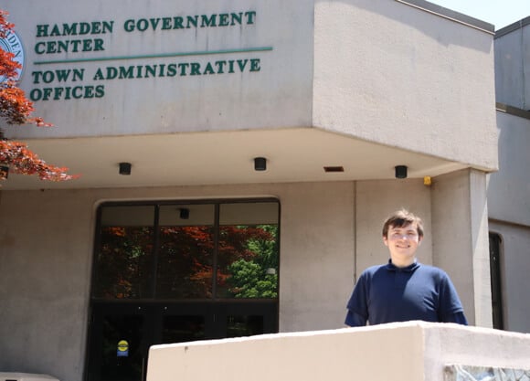 Michael Scott stands in front of building