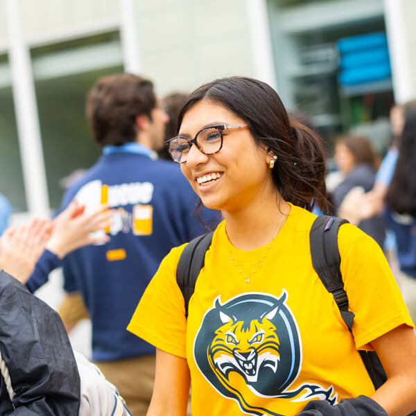 A student in a gold Bobcat shirt participates in an Orientation activity