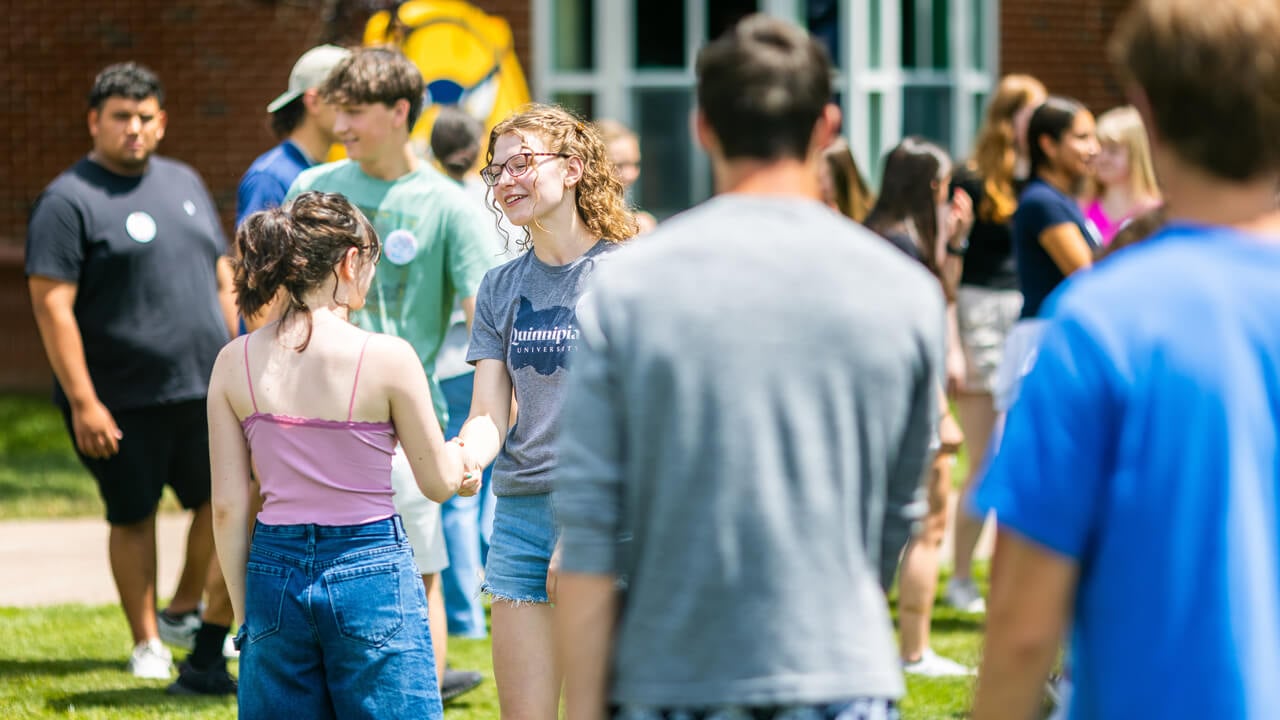 Two students shake hands