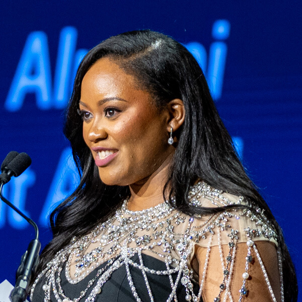 Headshot of Laeticia Iboki speaking at a microphone.