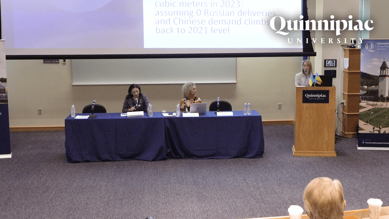 Panelists standing in front of projector