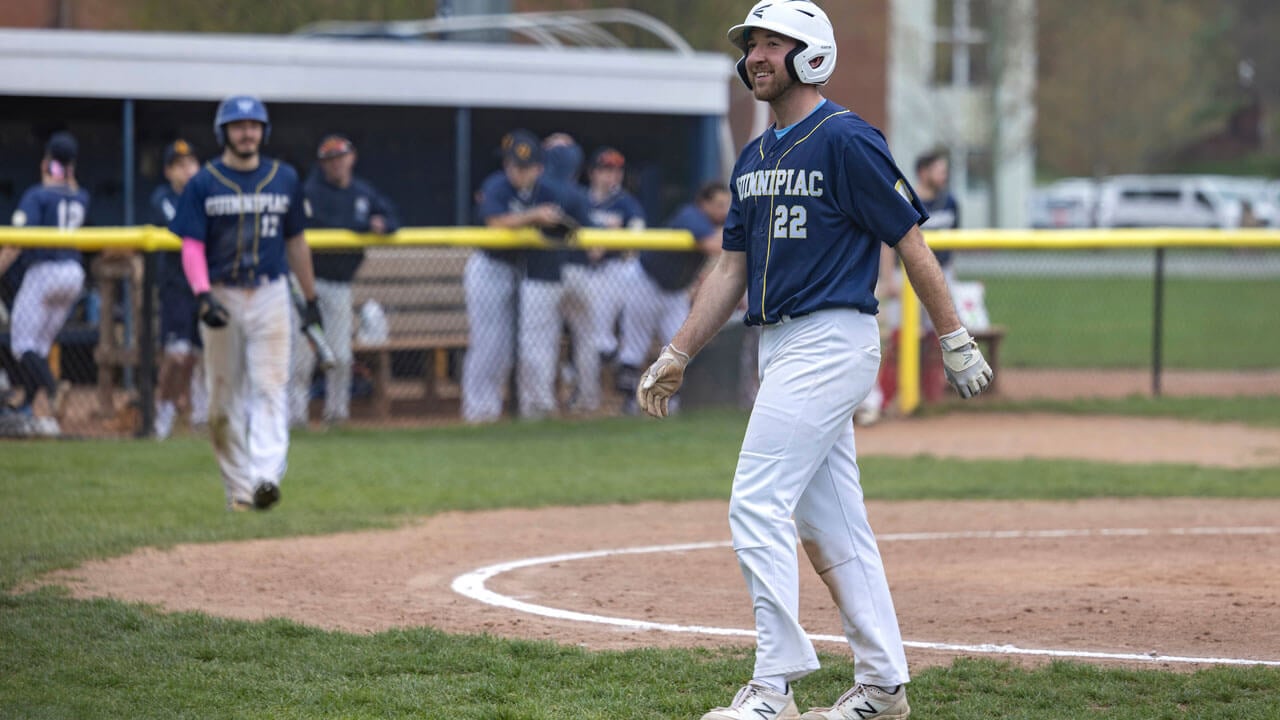 Student walking on baseball field