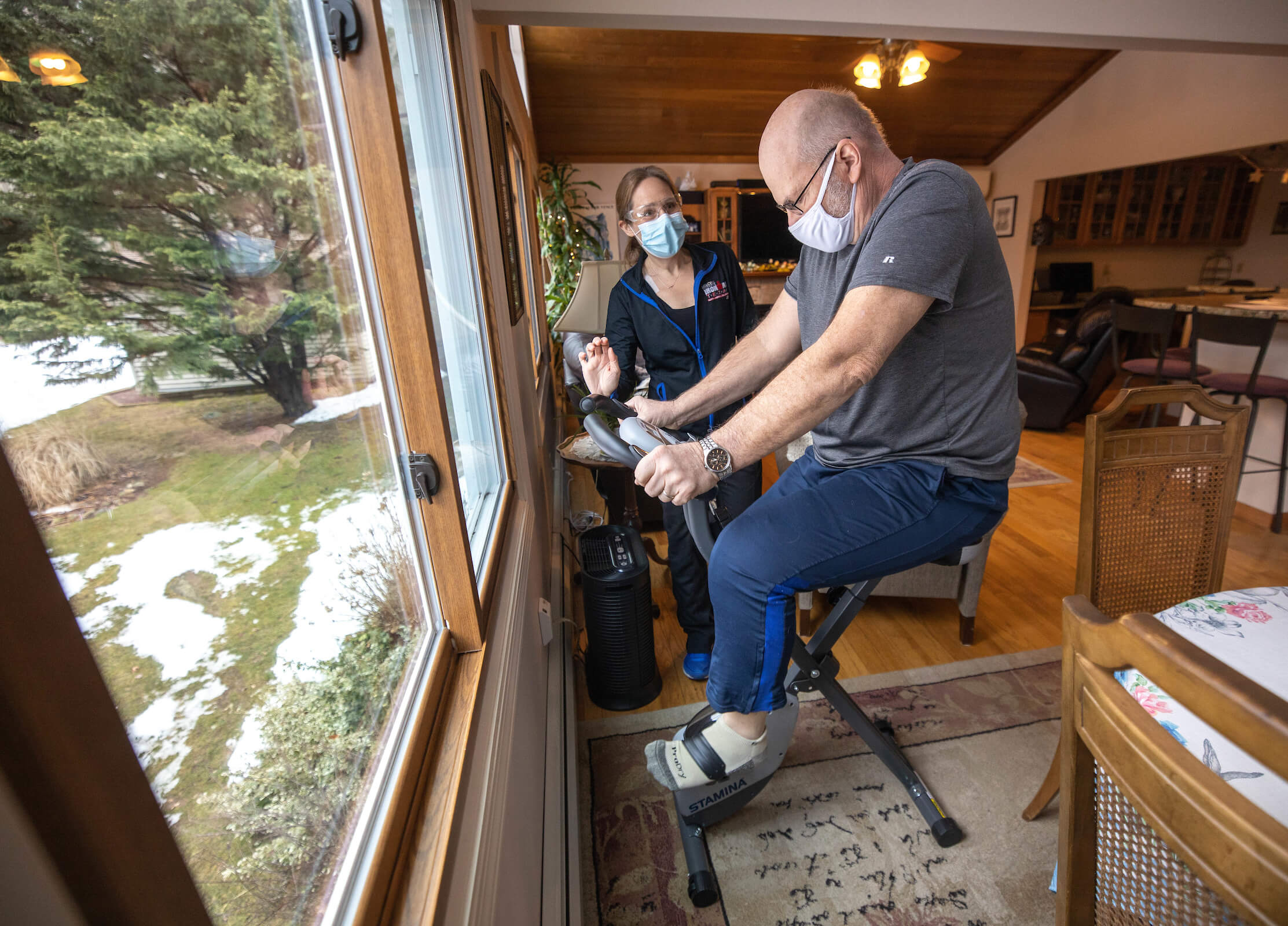 Professor rides a PT bike with former student teaching him how to use it