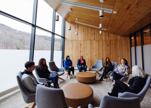 A group of students and a therapist participate in group therapy