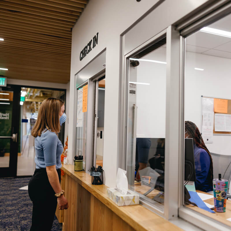 A female student checks in at the health services counter