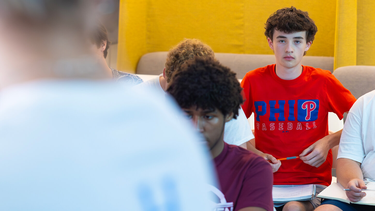 A high school student listening to a presentation during the Quinnipiac sports communications summer camp.
