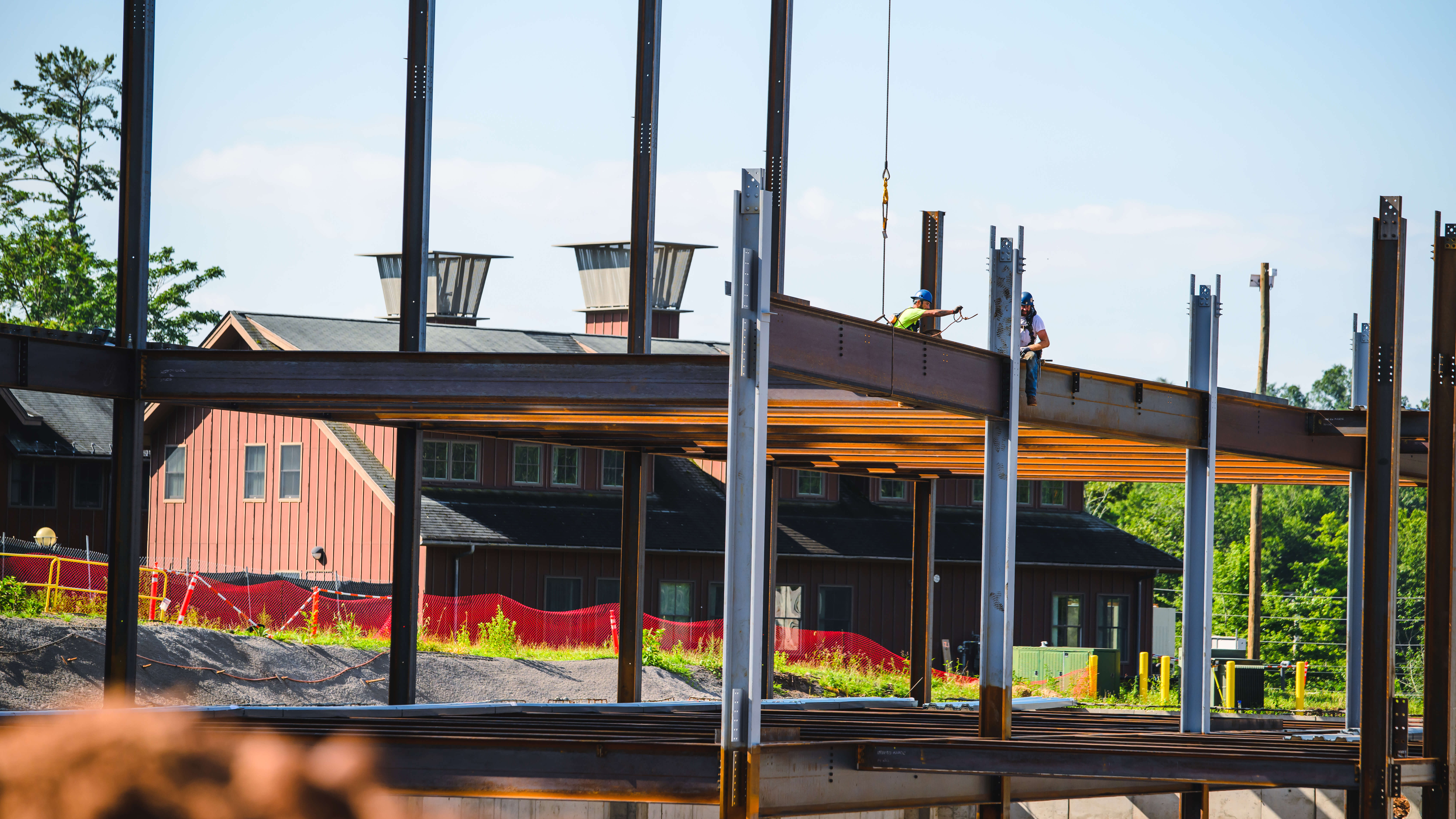 Workers sit atop the beams