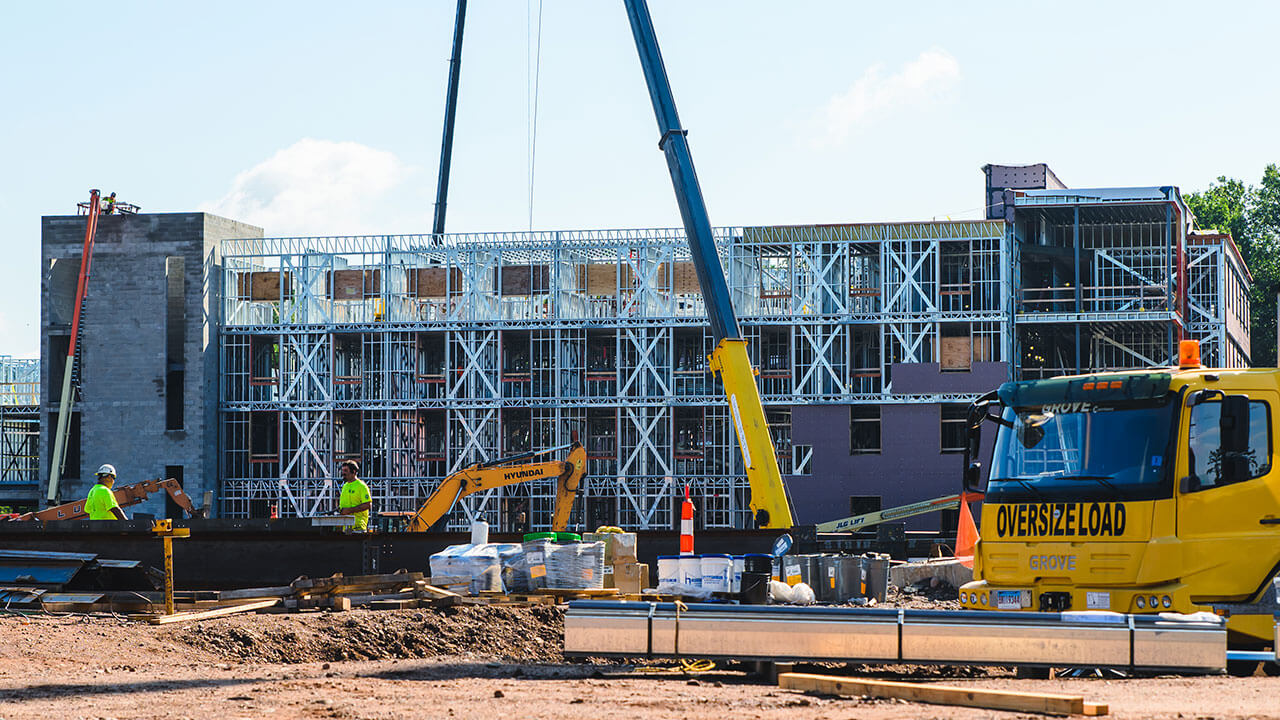 A crane in front of a newly built building