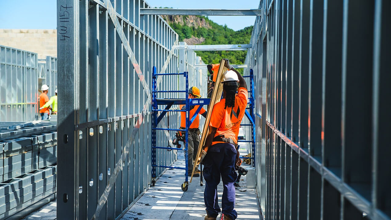 A construction worker carries materials