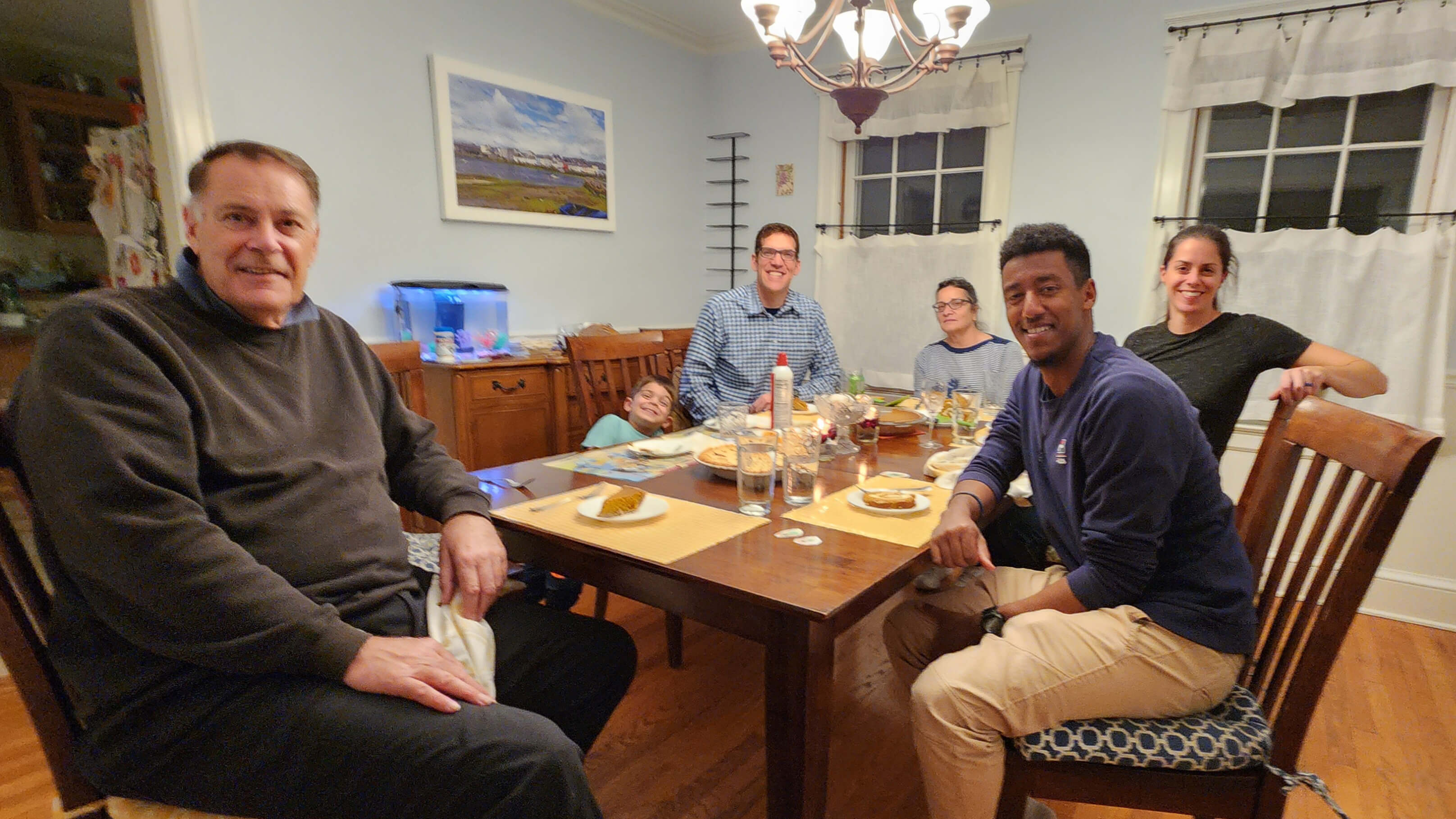 Student and Staff Member Sitting For Thanksgiving Dinner