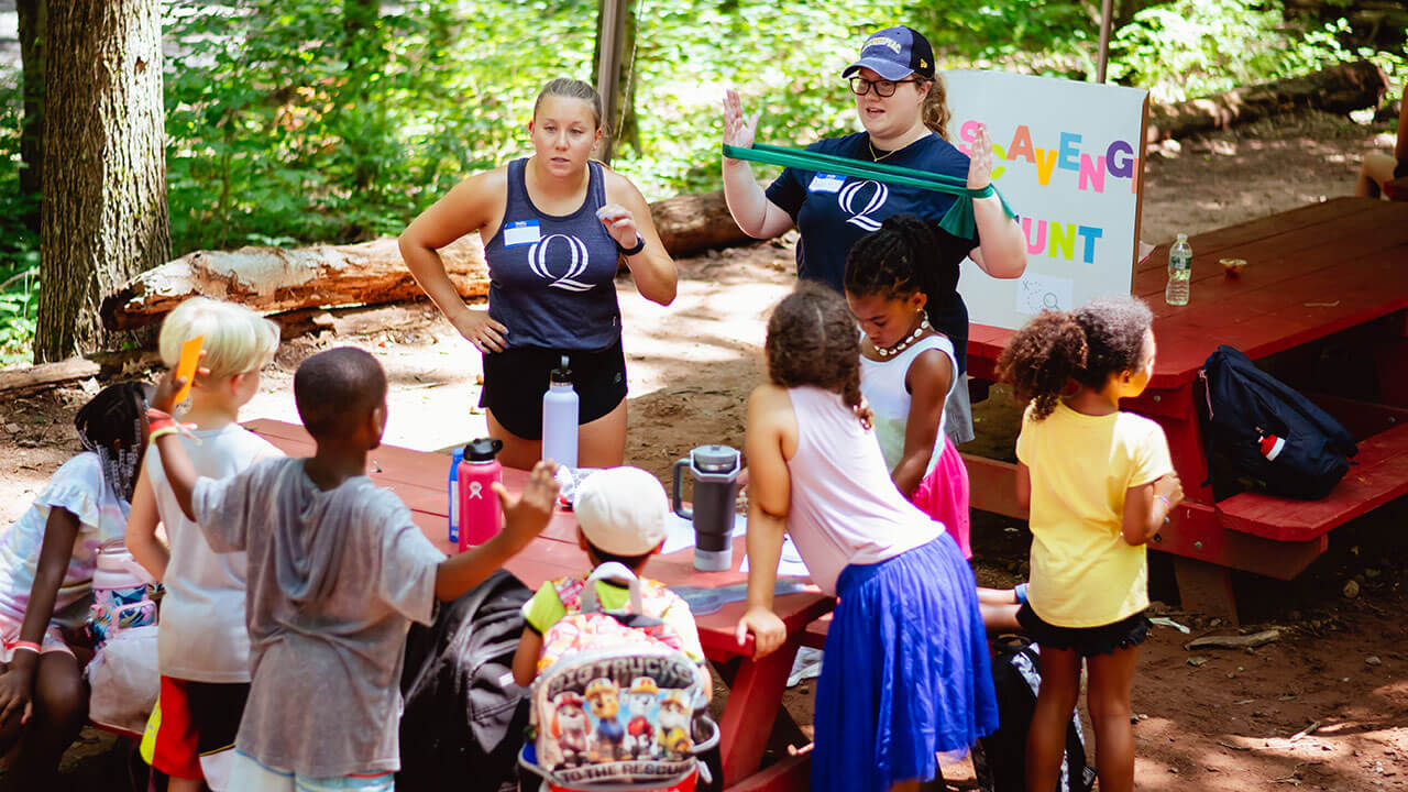 Students lead a scavenger hunt with campers in Hamden