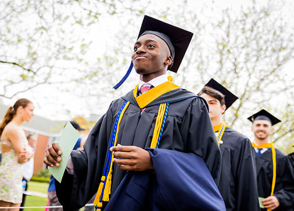 Olaundre Ffriend smirking in his cap and gown