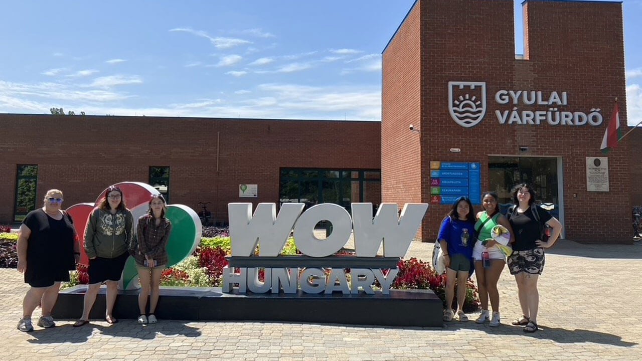 Students standing in front of the WOW Hungary building