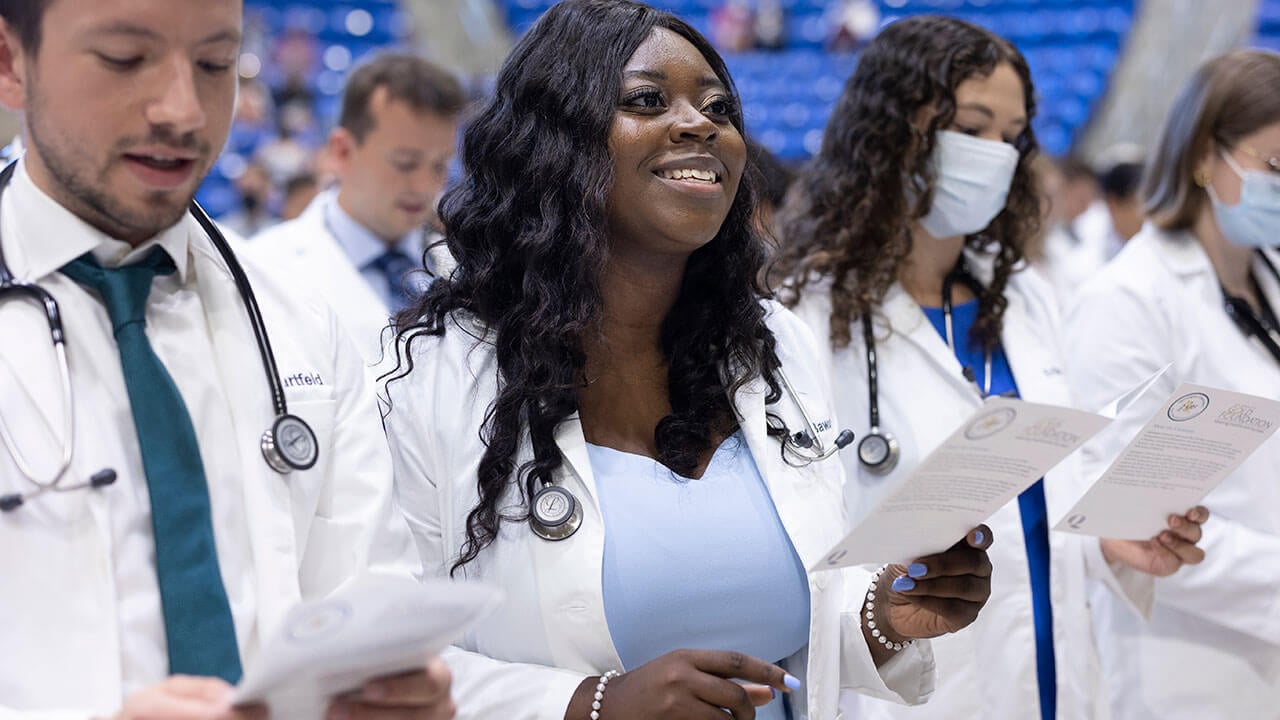 Medical graduates recite an oath during the ceremony