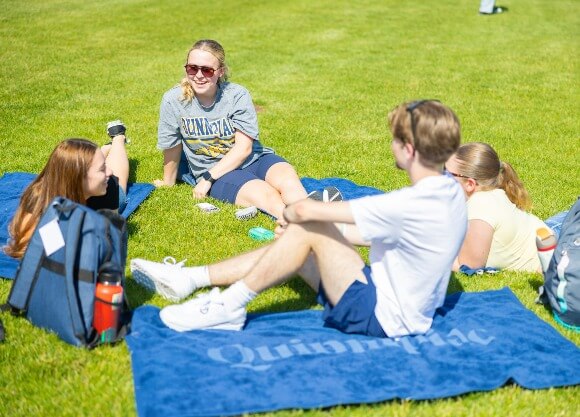Students sitting out on the Quad