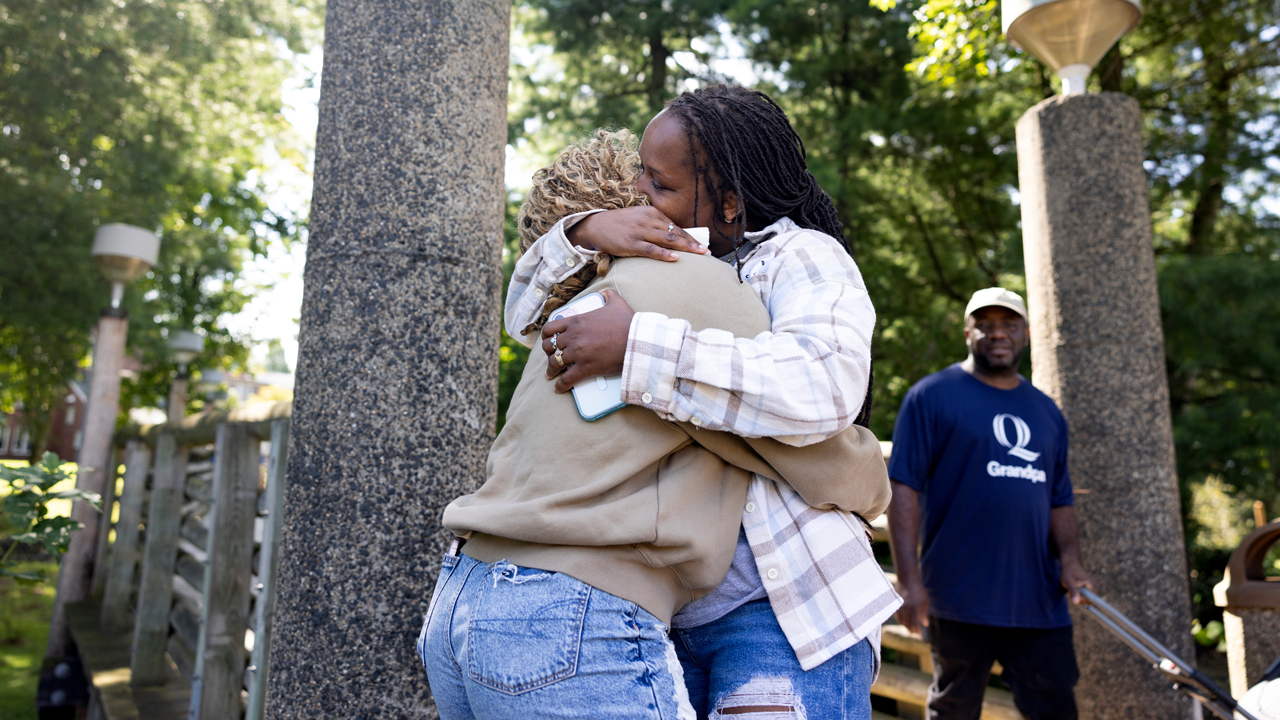 Two individuals hugging