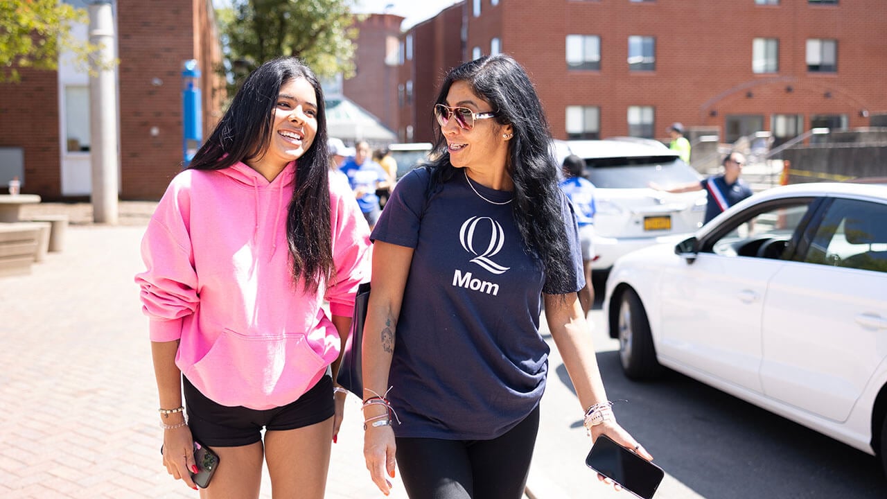 A mom and daughter walk down Bobcat Way