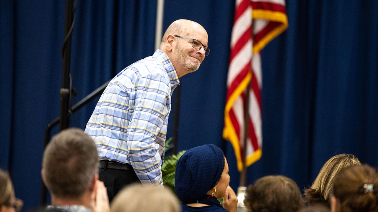 Robert Engle stands up in celebration of his award