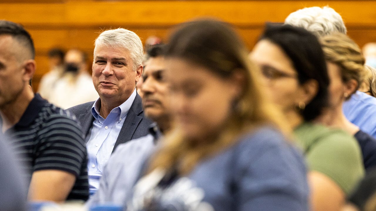 Dean Chris Roush sits with other faculty and staff members