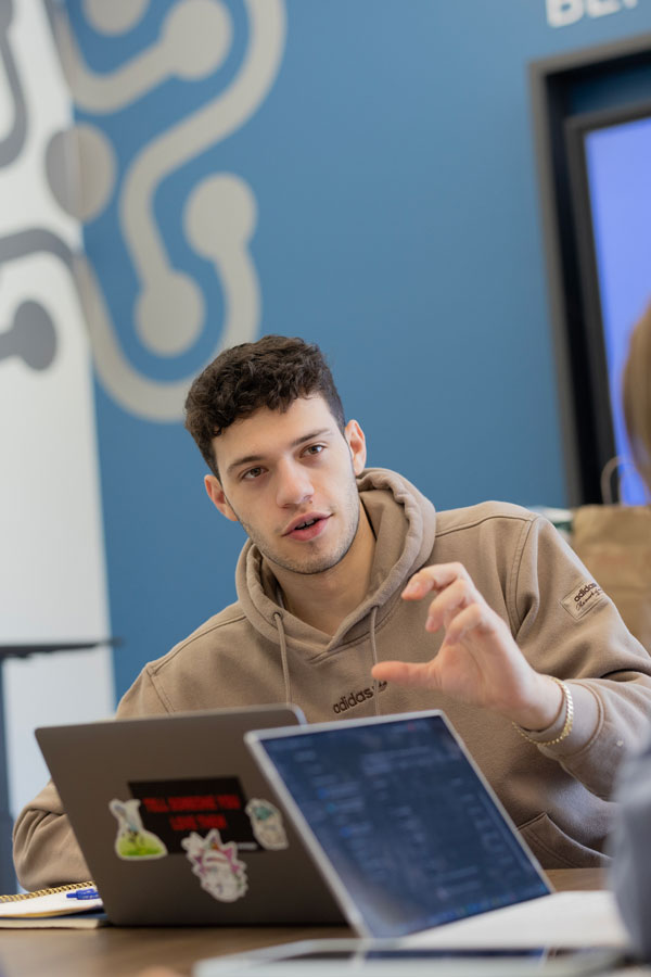 A male student speaking to someone out of frame