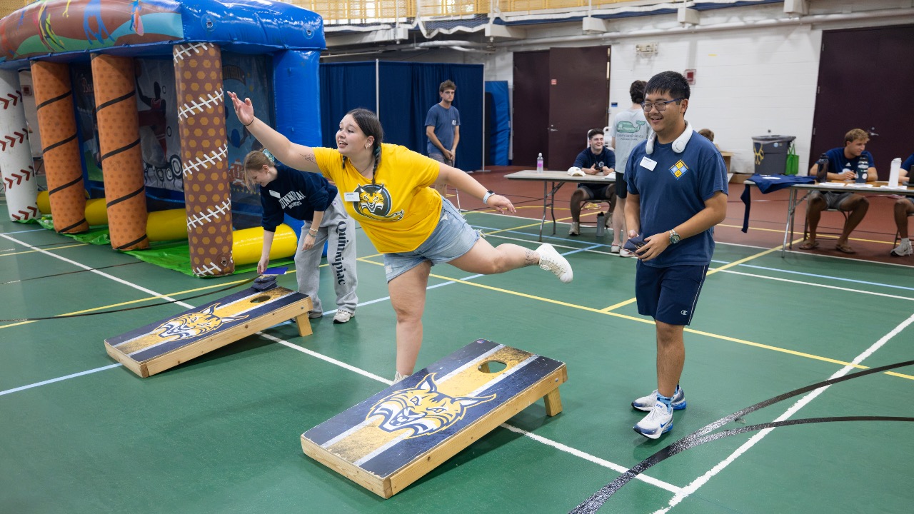 Students playing corn hole