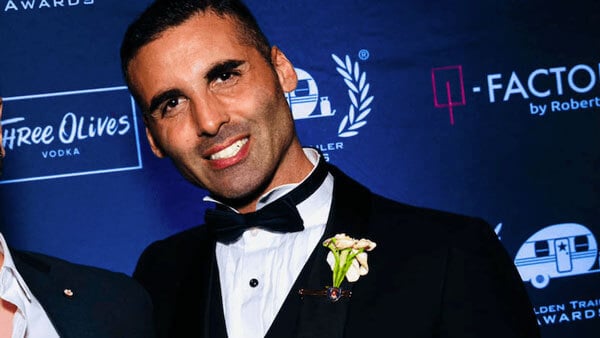 Brendan Amoruso in a tuxedo posing for a photo