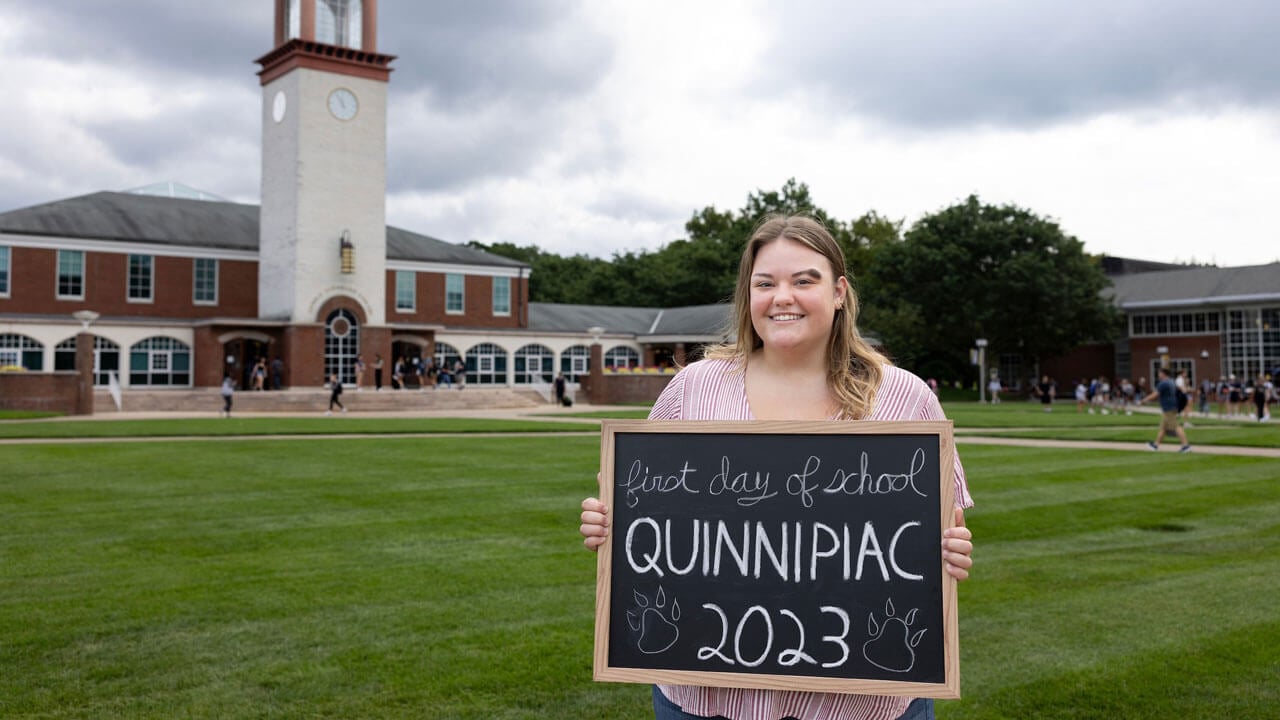 A student takes a photo in front of the clocktower