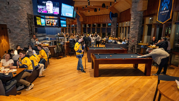 Bobcats enjoying a game of pool in On The Rock's Pub and Grill