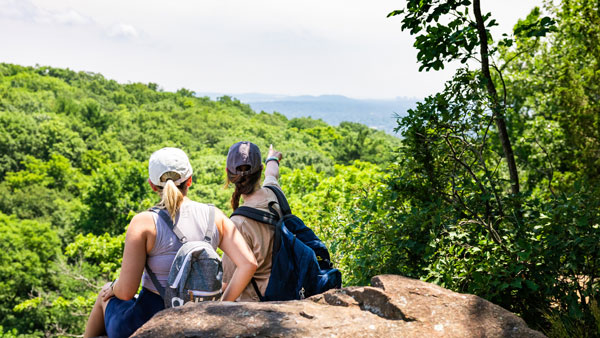 Ladies sitting on a rock enjoying the view after hiking the giant