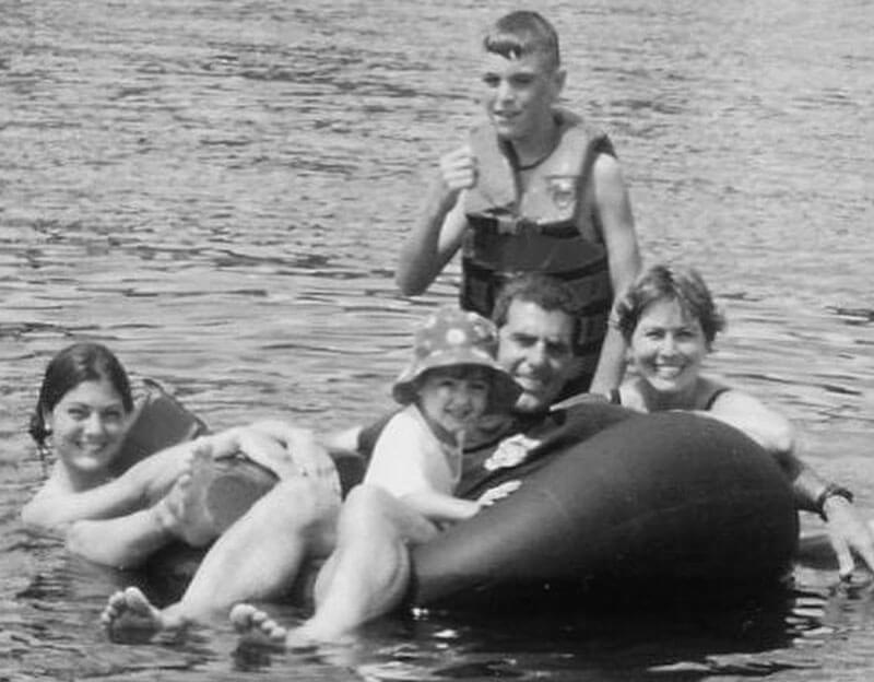 The Mascali family smile as they ride a large float on the lake