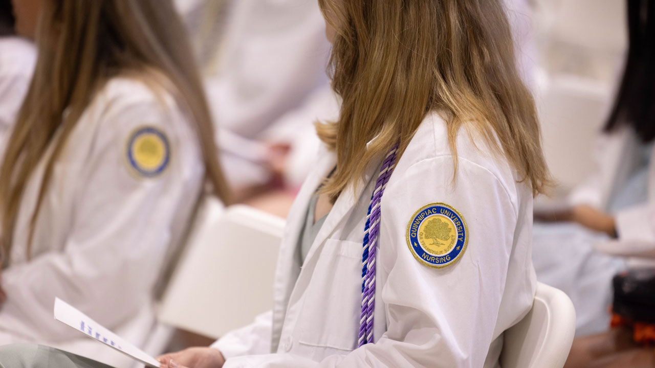 Photo of students sitting in crowd during the pinning ceremony