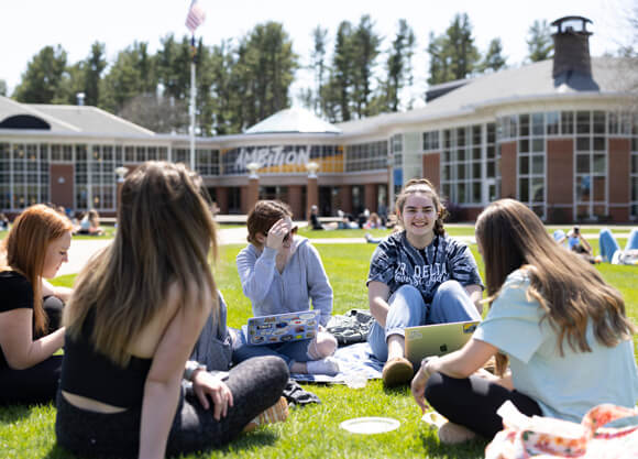 a group of female students studying outside