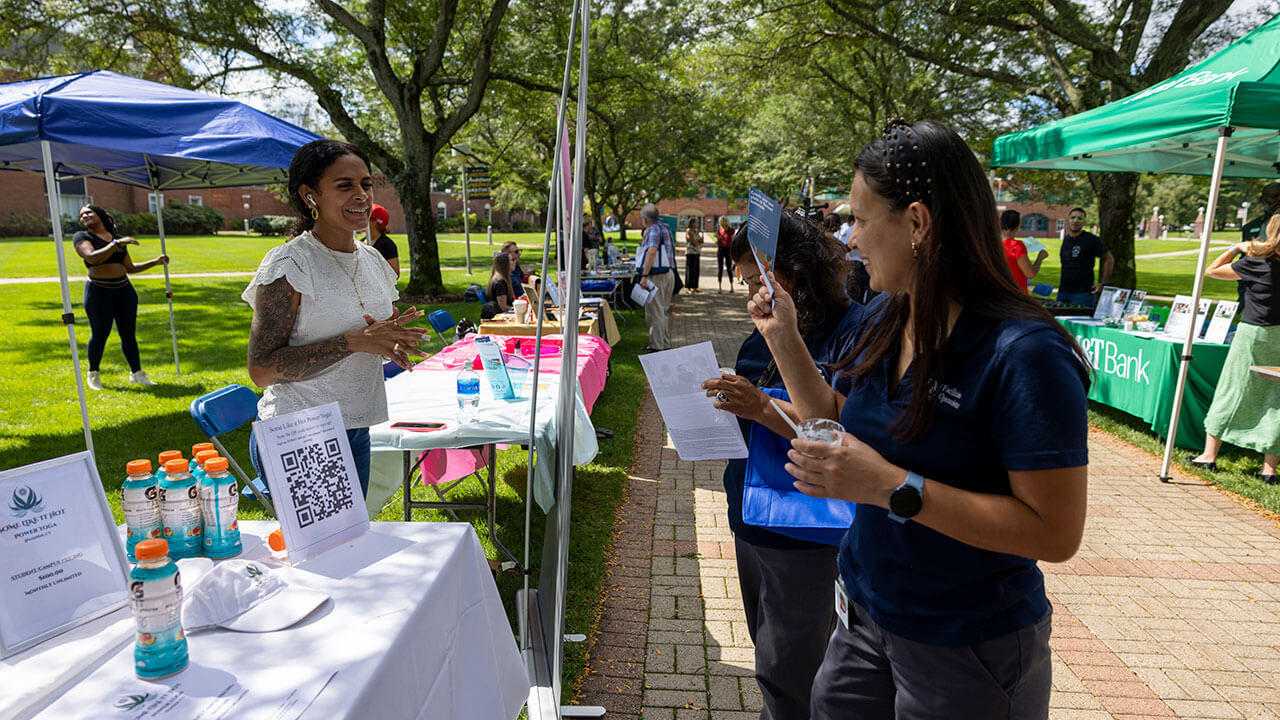 Student looks at local business stand