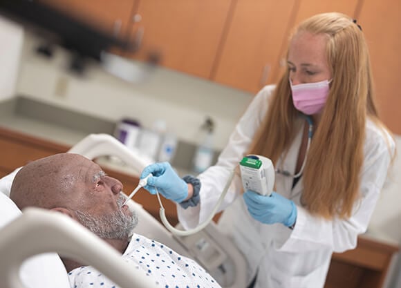 A nursing student works on a simulation.