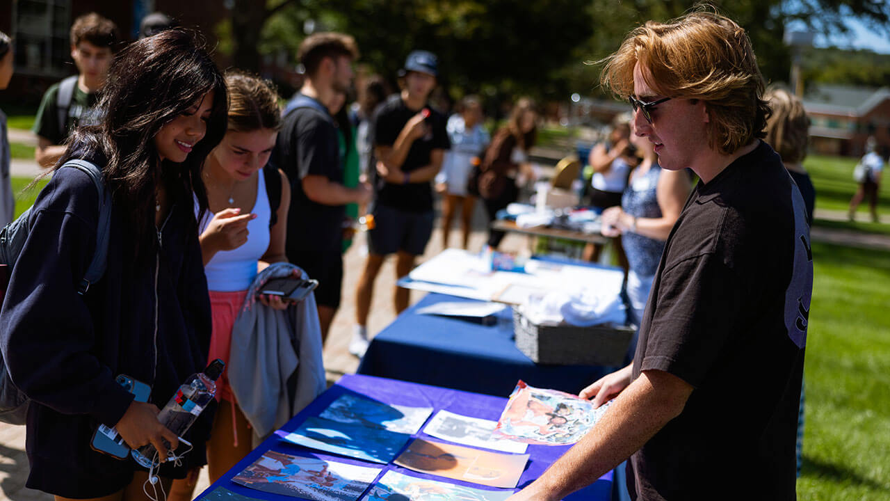 Cole Johnson sells his custom art pieces on the Quad