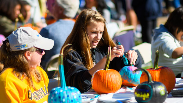 Student decorating a pumpkin