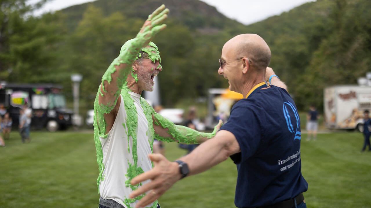 Tom Ellett gives hug after getting slimed at Bobcat Weekend