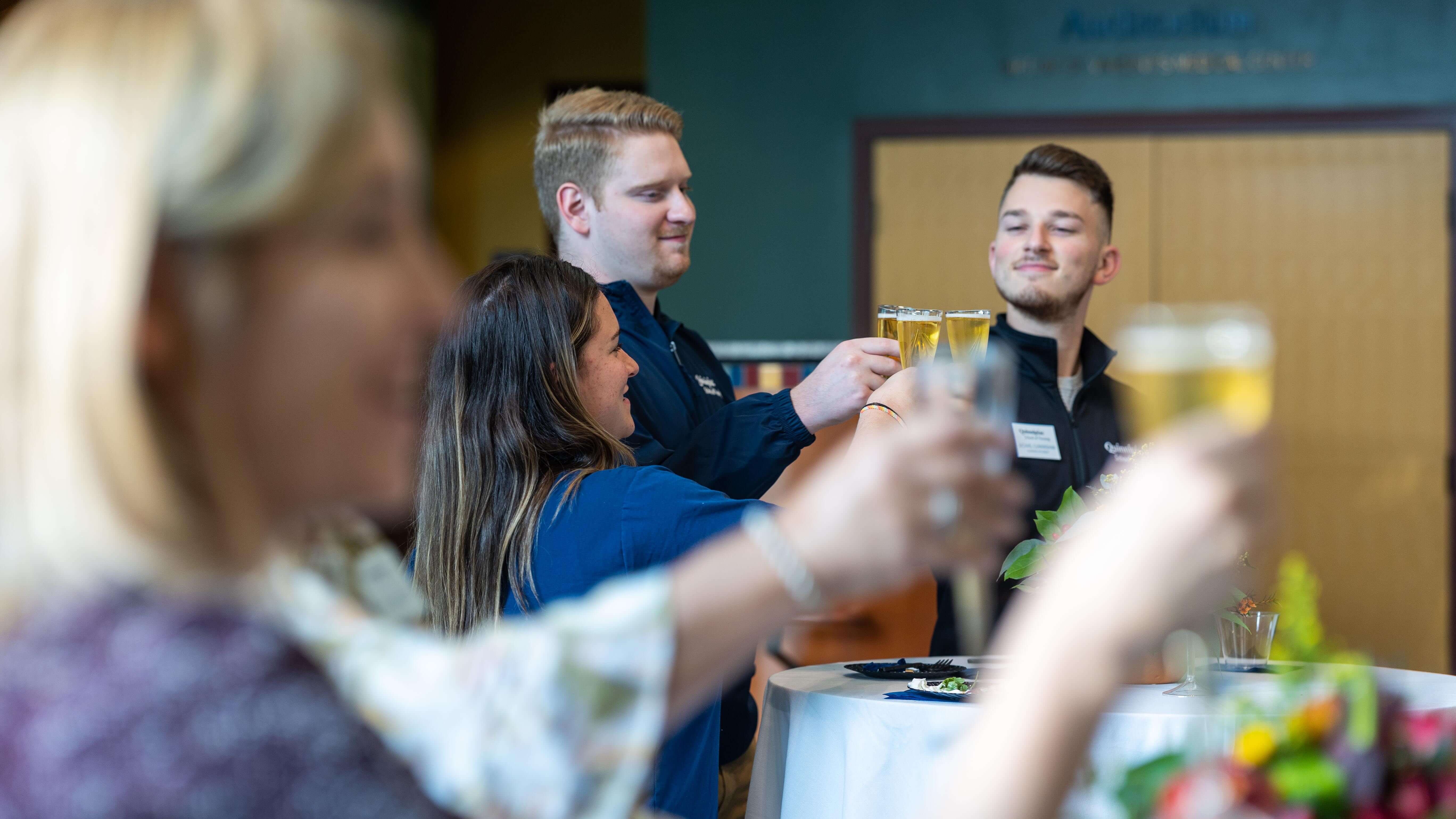 Attendees toast in honor of the School of Nursing's 50th anniversary