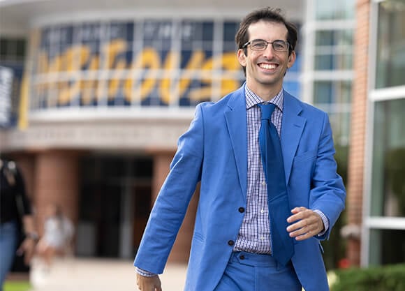 Jamie DeLoma walks across the Quinnipiac Quad with ambition.