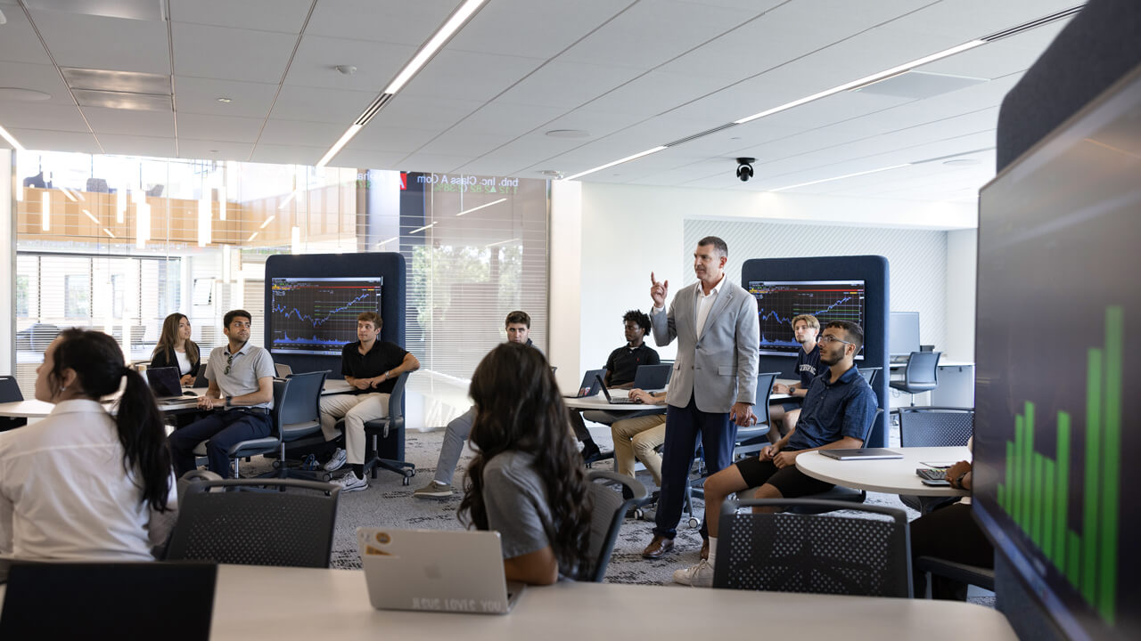A professor teaching a class in the Financial Technology Center.