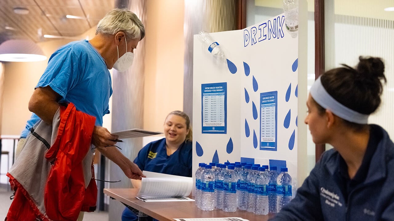 Local residents pick up water from a water station during Fall Prevention Day on the Quinnipiac North Haven campus