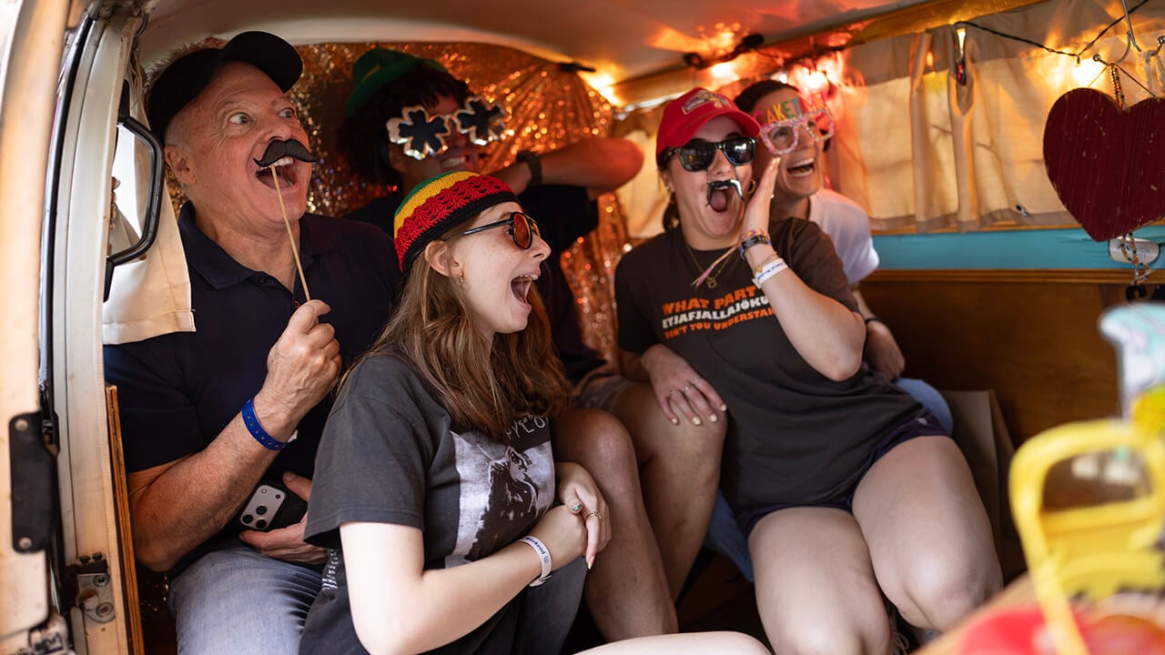A family poses for a photo in a photo booth van.