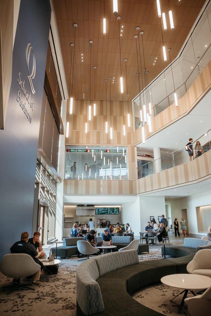 Students and faculty socialize in the School of Business atrium.