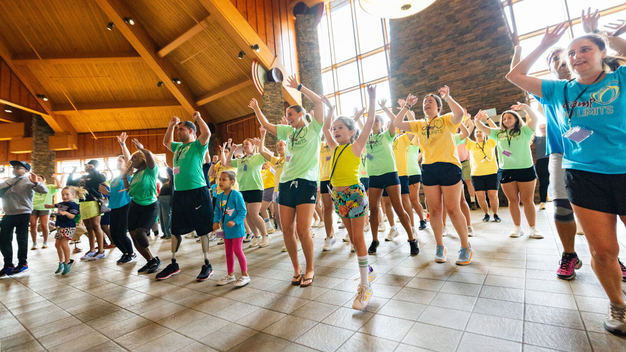 Campers, counselors and families of Camp No Limits participate in energizers and pilates in the Rocky Top Student Center on Quinnipiac University’s York Hill campus