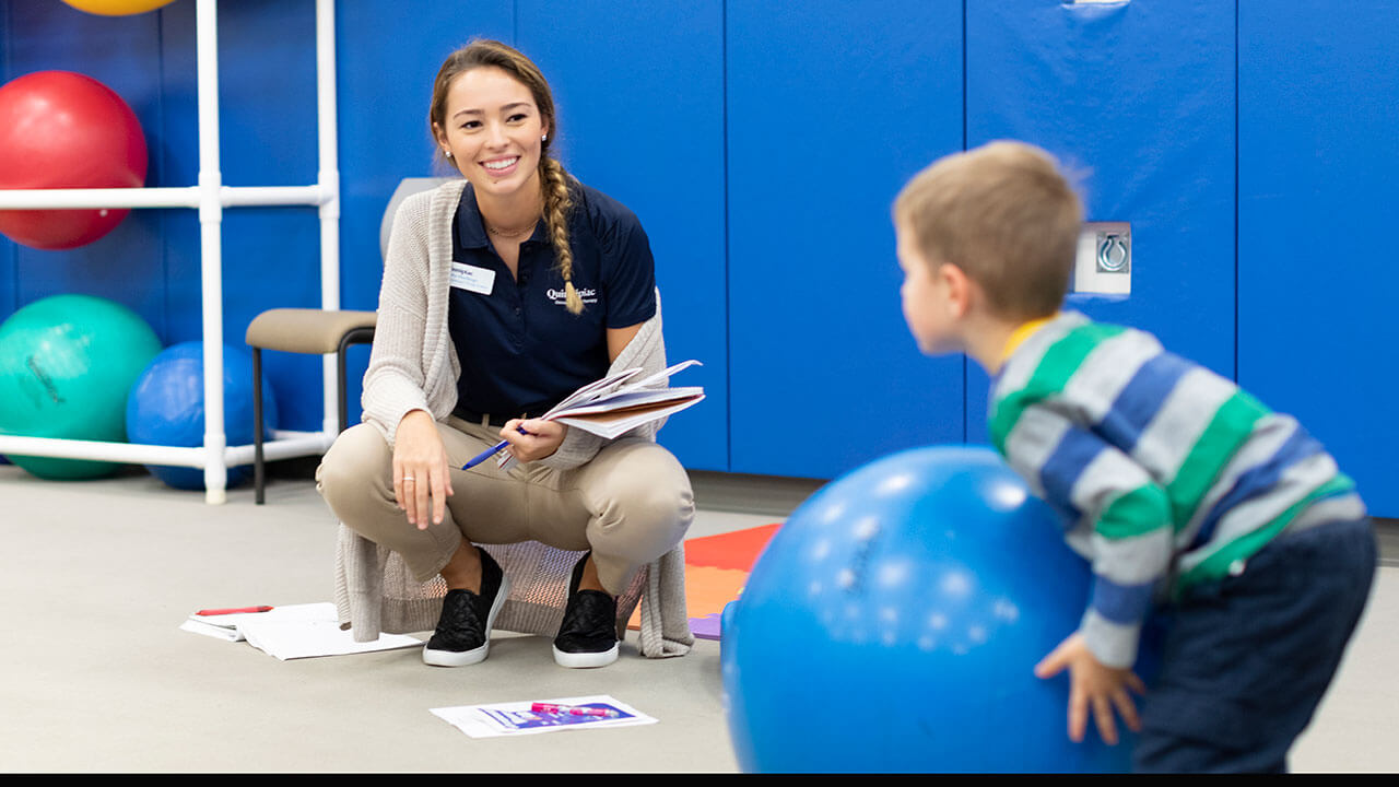 Quinnipiac University School of Health Sciences occupational therapy student Kaitlin Muehlberger interacts with toddler Steven Tilke during Baby Day Observation and Play in the Movement Lab at the North Haven Campus