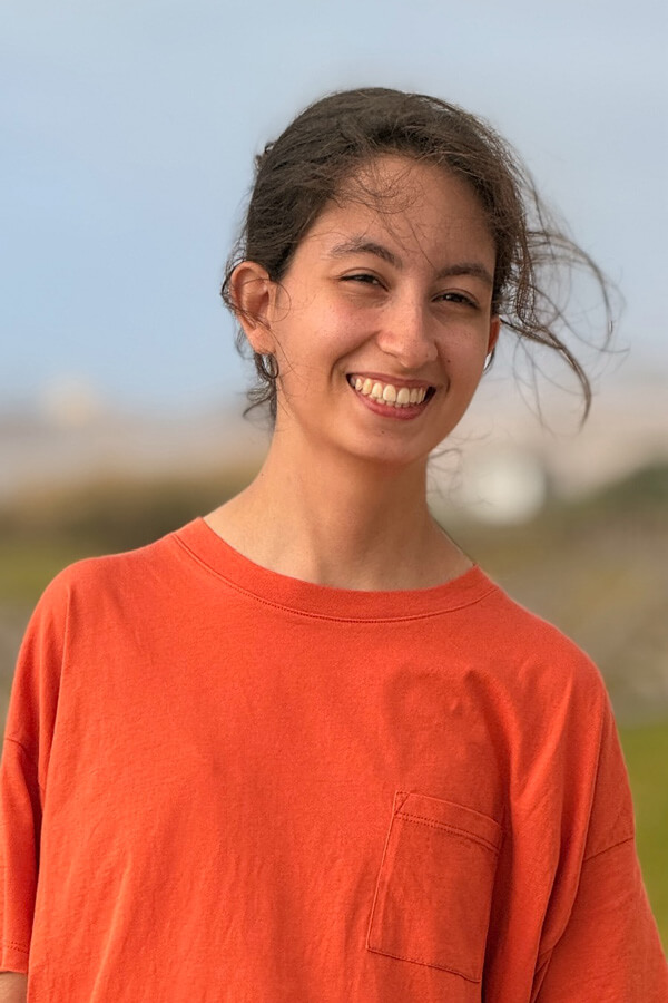 Photo of Safia Benbrahim wearing an orange T-shirt.